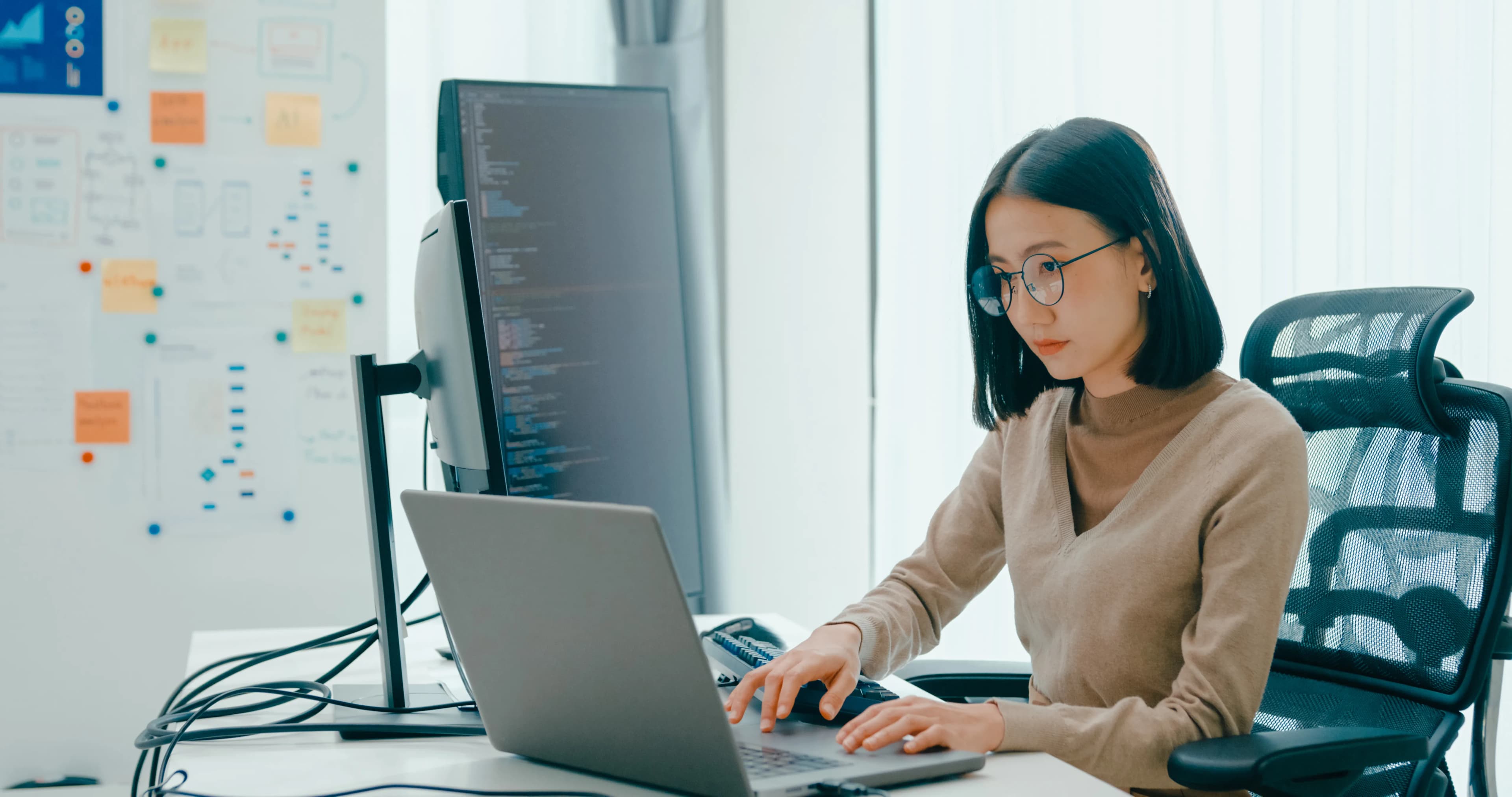 Software developer writing code with AI on a computer — Claude Opus 5.5 announcement