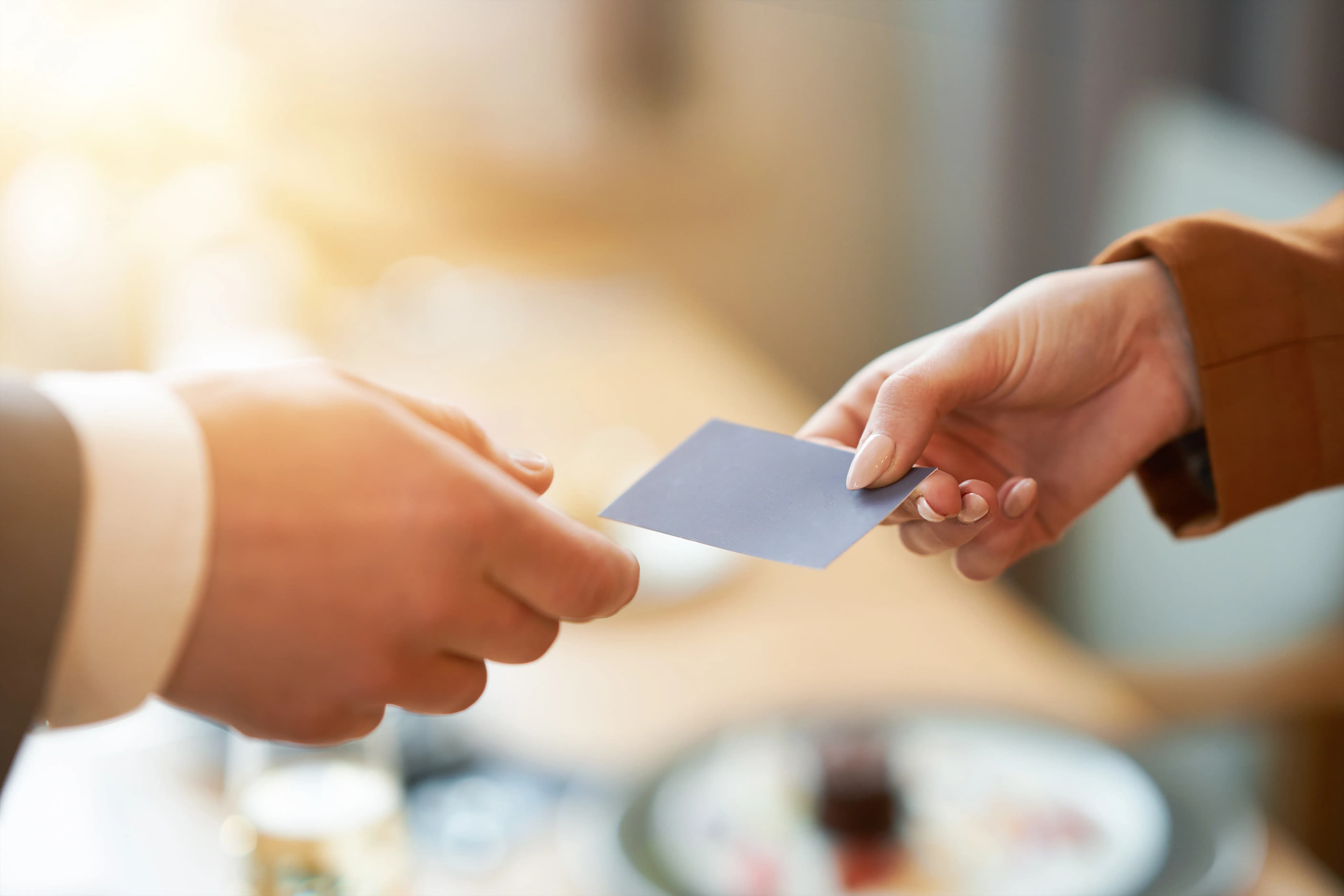 Two business people exchanging a business card