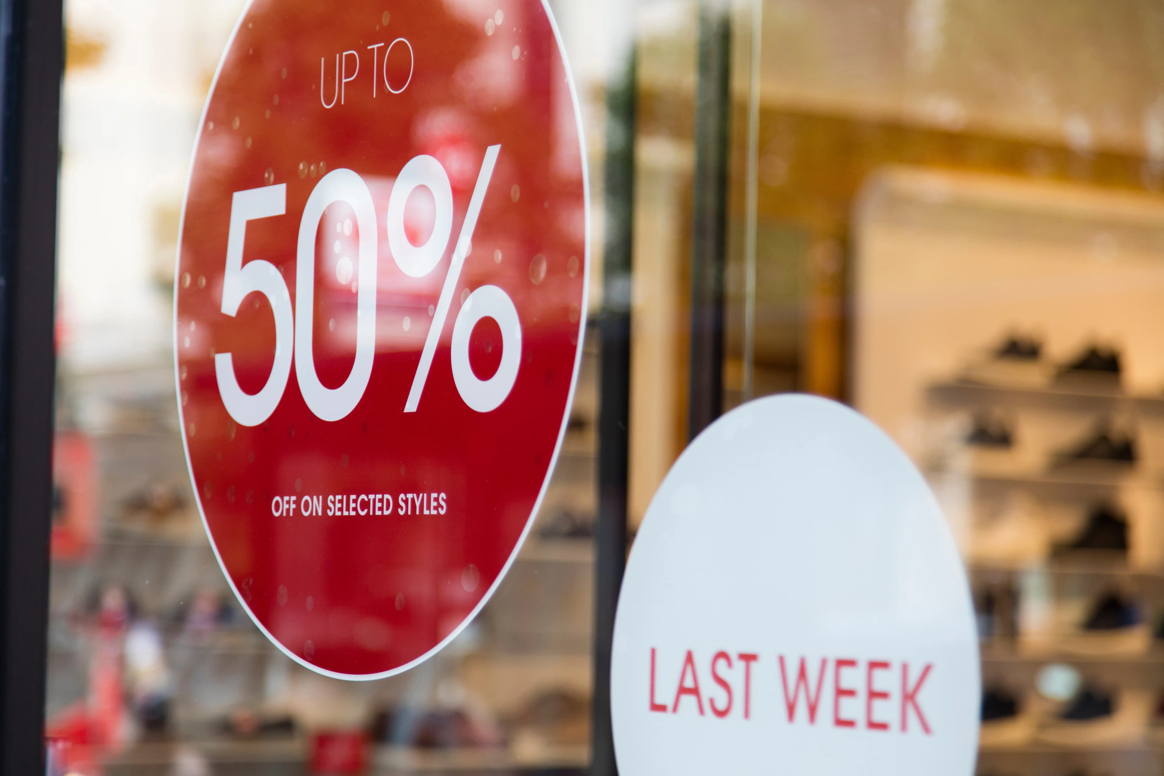 An up-to-fifty-percent sale sign in a shop window