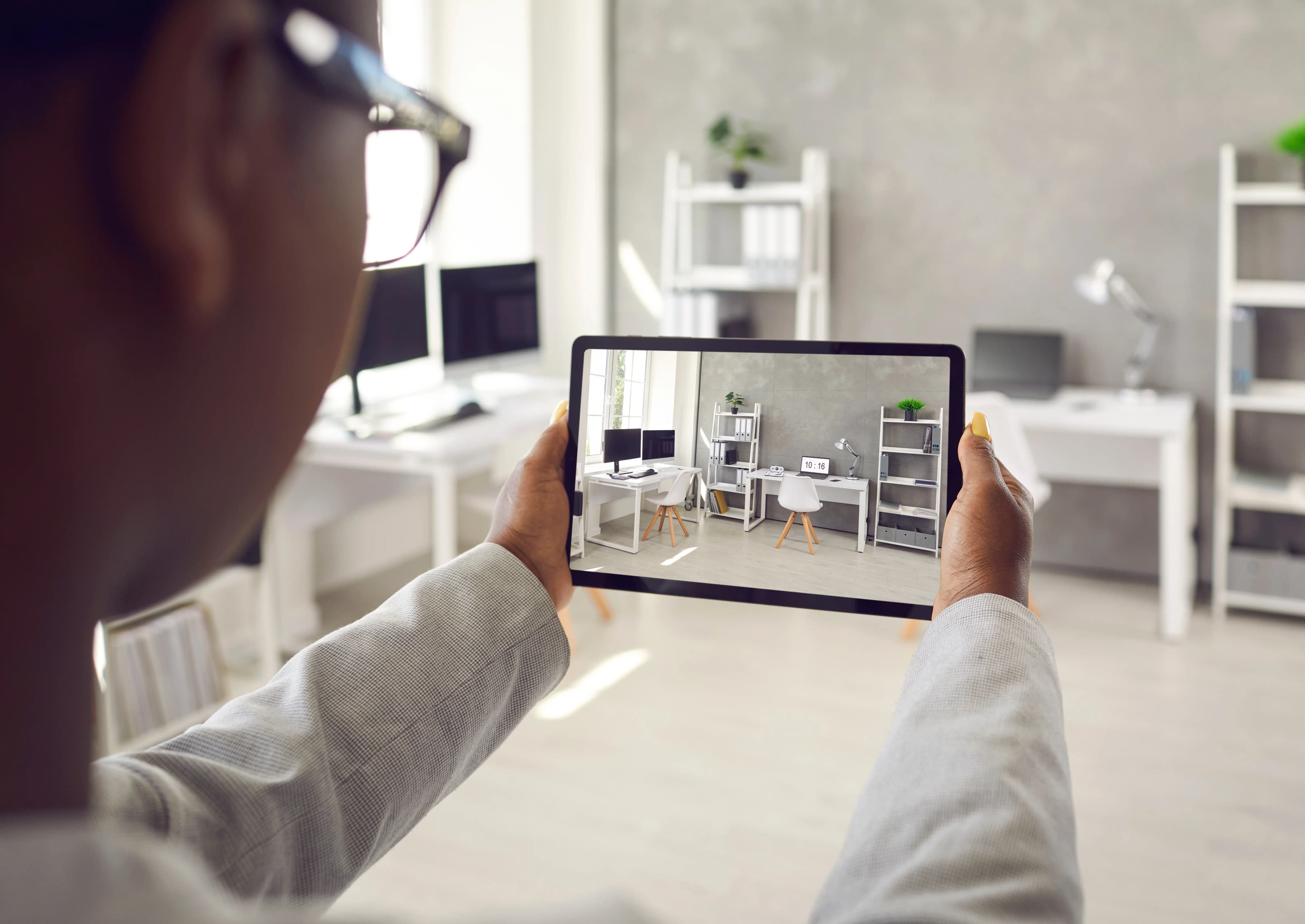 Real estate agent showing apartment interior photos on a tablet