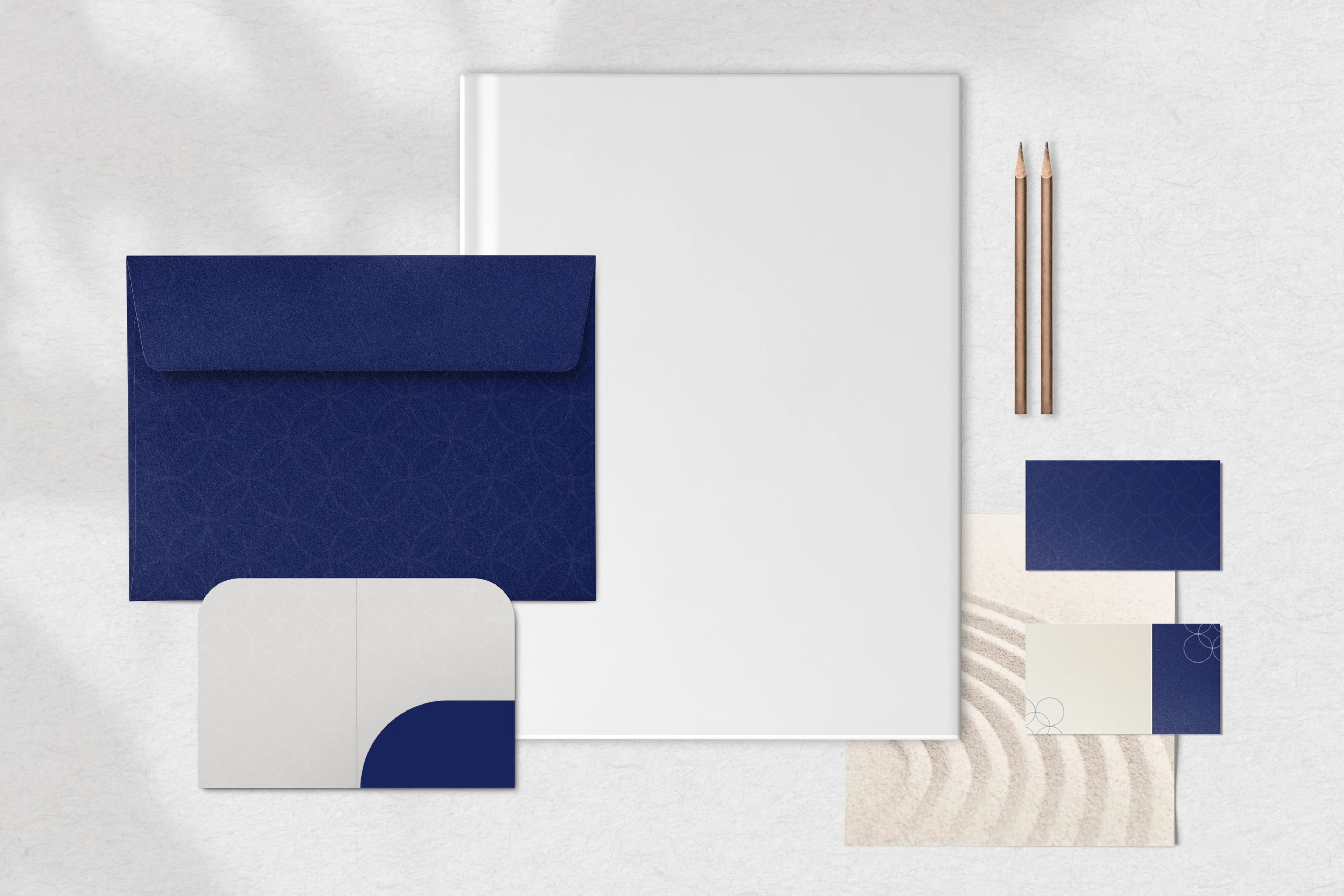 Top view of a blue and white corporate identity stationery set with envelope, business cards and letterhead