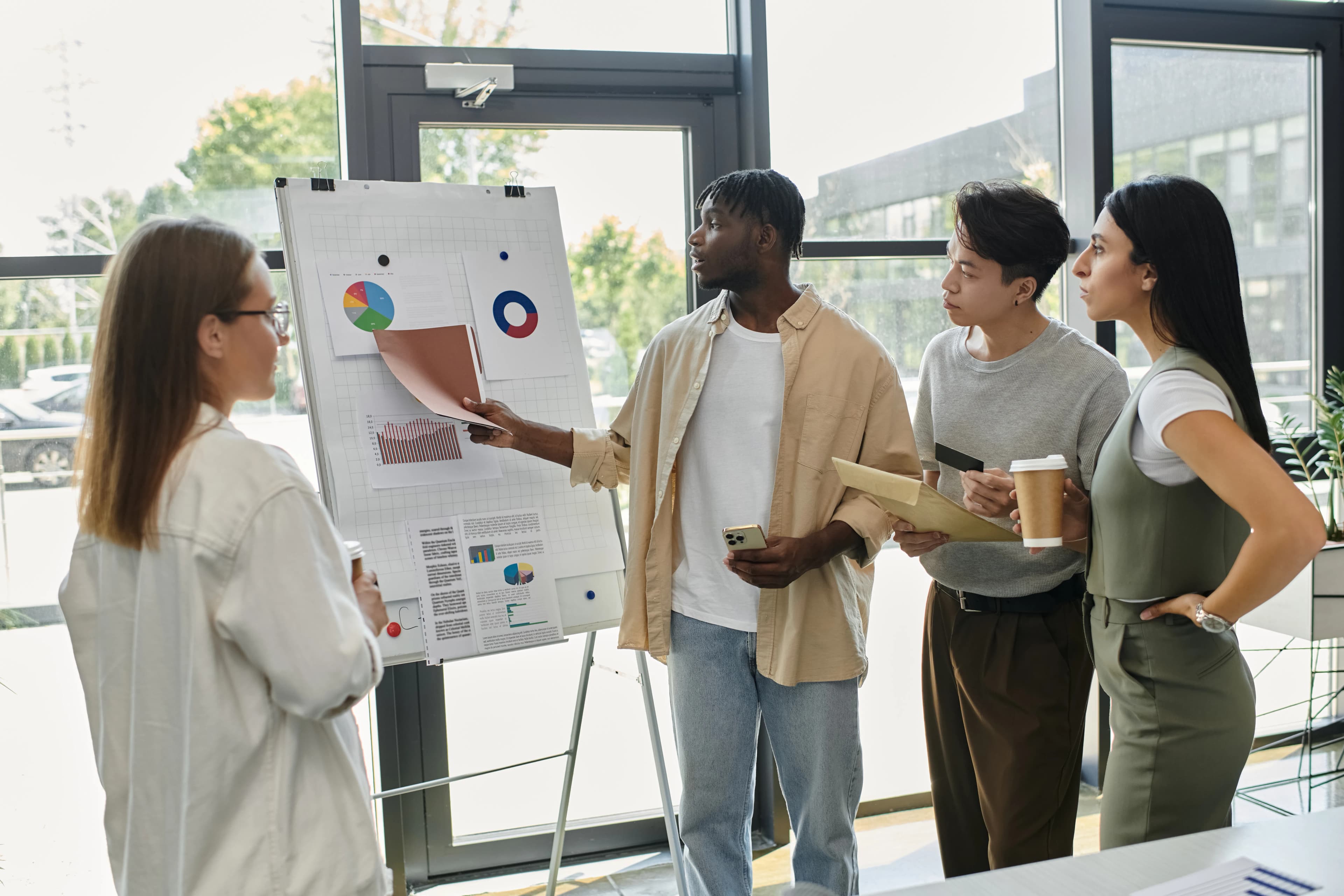 A young team discussing strategy around a whiteboard in an office