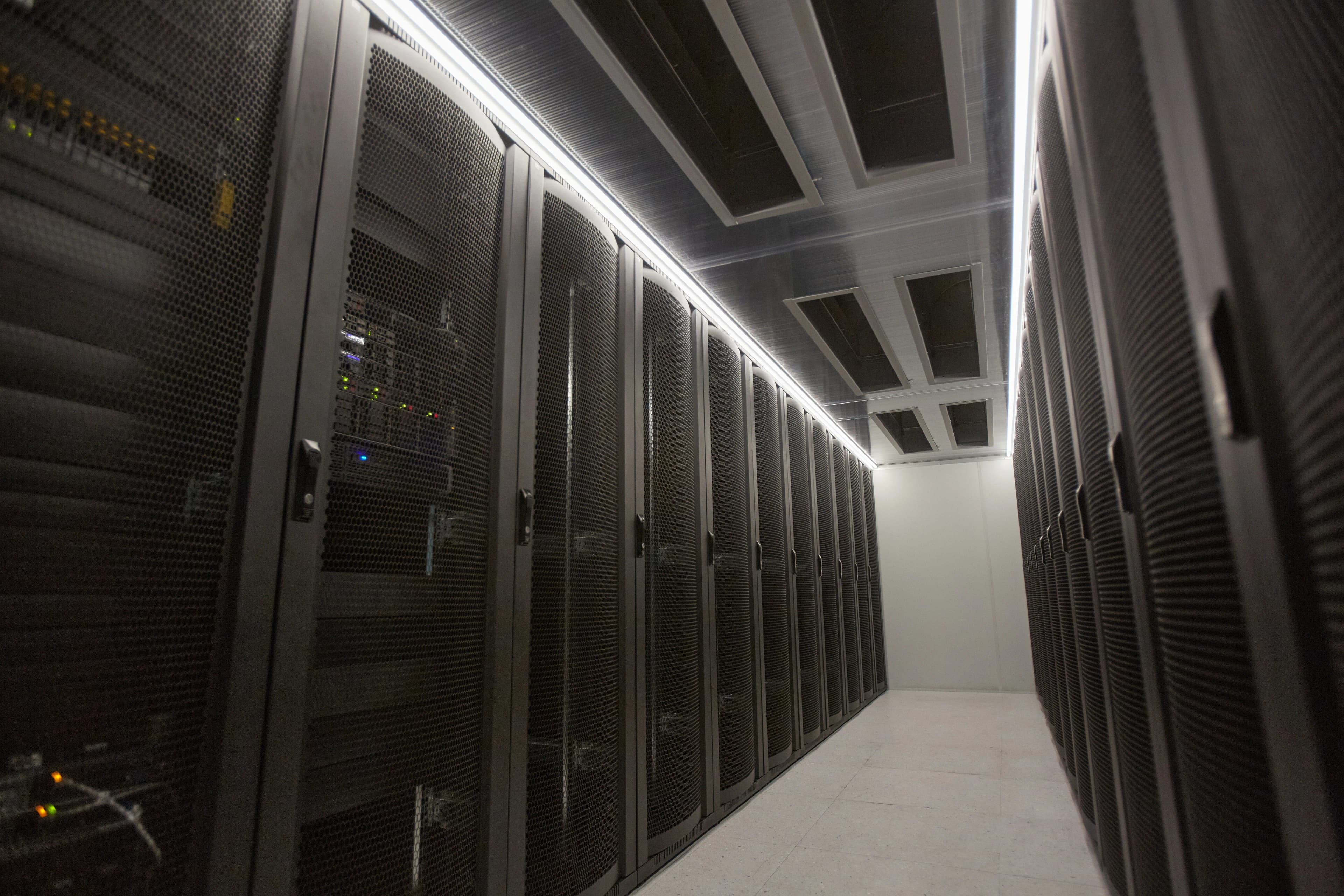 A long corridor of server racks in a data centre