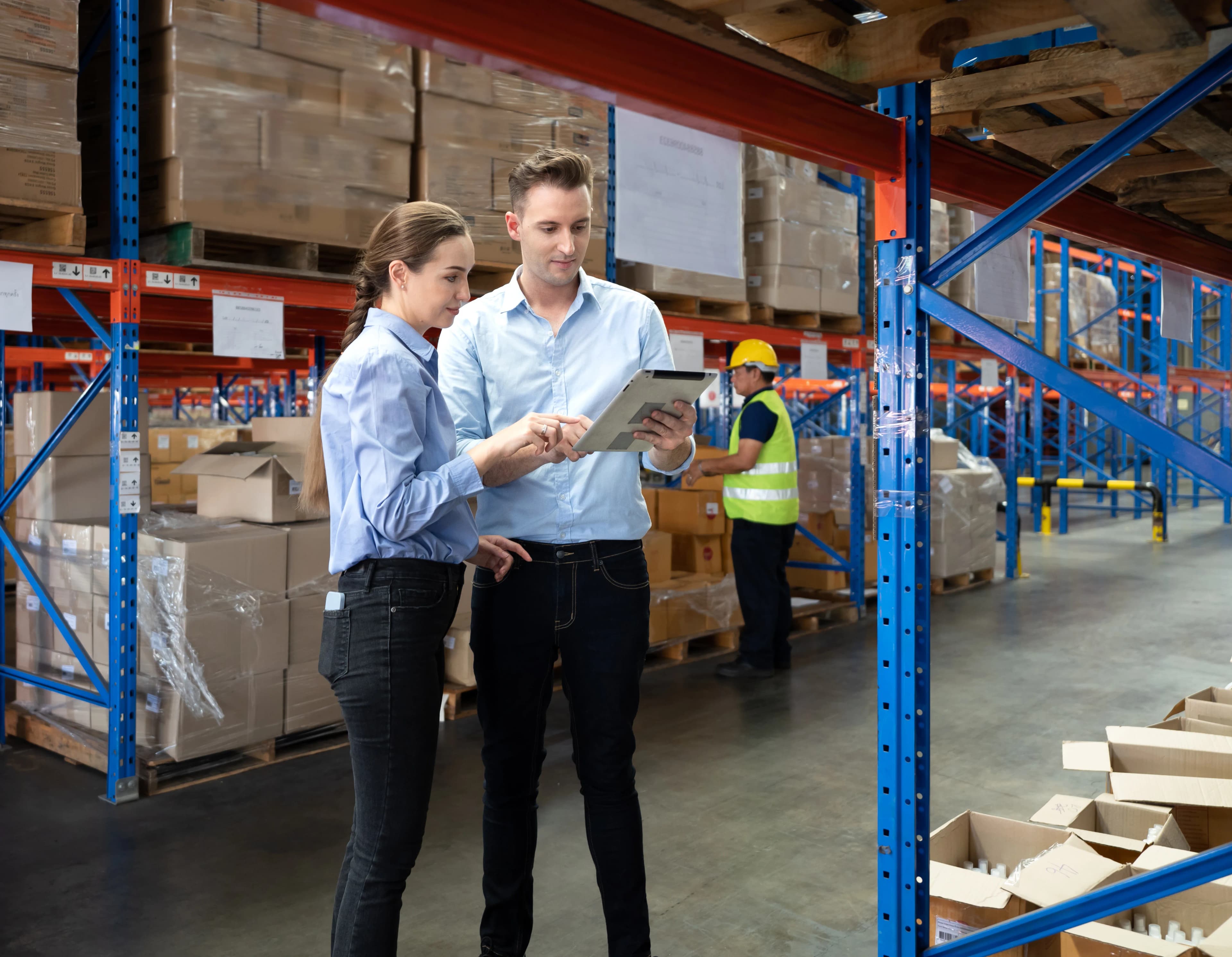 Warehouse manager and a client checking shelf inventory on a tablet
